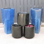 A pair of large blue pots, 90cm tall, together with a set of three black pots,