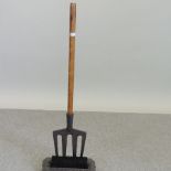 A long handled bootscraper and brush,