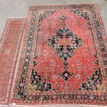 A large Persian woollen carpet, with all over designs on a red ground, 364 x 260cm,