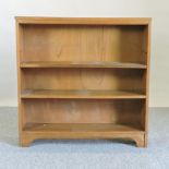 A walnut dwarf open bookcase,