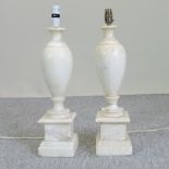 A pair of white marble table lamps,