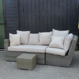 A rattan sofa, in two sections, with loose cushions, together with a side table, 41cm,