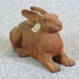 A rusted metal model of a rabbit,