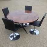 A hardwood circular dining table, on a metal base, 136cm,