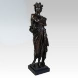 A patinated bronze figure, shown standing wearing classical robes on a plinth base, signed Daiov,