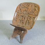 An African carved hardwood folding chair