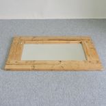 A large rustic wooden framed wall mirror,