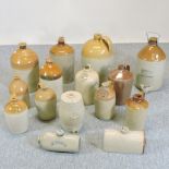 A collection of twelve various stoneware advertising jars and barrels,