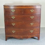 A Regency mahogany and inlaid bow front chest, containing two short over three long drawers,