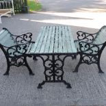 A cast iron and wooden garden table,