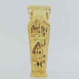 An early 20th century Chinese carved bone vase, decorated with figures, 15.