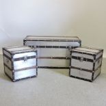 A graduated set of three aluminium and wooden bound trunks,