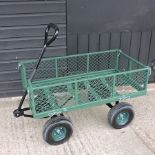 A green painted metal garden trolley,