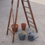 A collection of terracotta pots, together with a galvanised bucket,