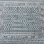 A Bokhara carpet, with all-over design, on a green ground,