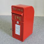 A red painted metal GPO postbox,