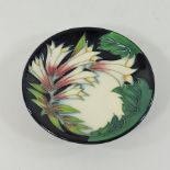 A Moorcroft pottery pin tray, dated 2004, 12cm diameter,