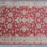 A Ziegler carpet, with floral designs, on a red ground,