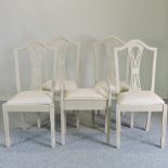 A set of four cream painted dining chairs,