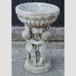 A reconstituted stone bird bath,