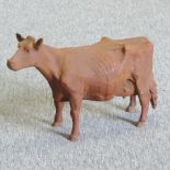 A rusted metal model of a cow,