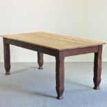 An early 20th century scrubbed oak farmhouse dining table, having a plank top, with a single drawer,