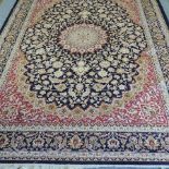 A Keshan carpet, with a large central medallion, on a blue ground,