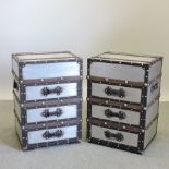 A pair of aluminium and wooden bound bedside chests,