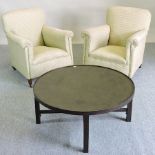 A pair of 1920's green and cream upholstered armchairs, together with a circular coffee table,