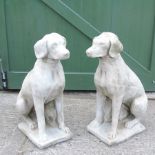 A pair of reconstituted stone dogs,