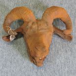 A rusted metal ram's head,