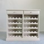 A grey painted wooden wine rack, containing two short drawers,