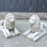 A pair of reconstituted stone garden models of lions,