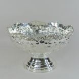 A silver plated punch bowl, with relief decoration,