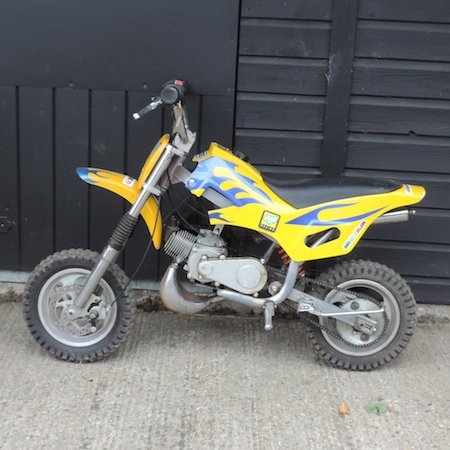 A Shoei child's yellow petrol trials bike,