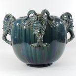 A 19th century majolica blue glazed jardiniere, relief decorated with four satyr heads,