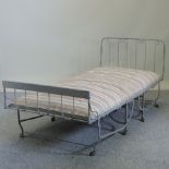 A grey painted metal day bed,