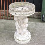 A reconstituted stone figural bird bath,