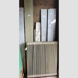 A collection of various sections of marble, together with a cast iron radiator,