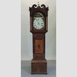 An early 19th century oak cased long case clock, having a painted arched dial, signed Thos.