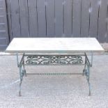 A green painted iron coffee table, with a marble top,