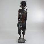 An ethnic carved wooden figure of a man,