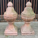 A pair of terracotta gatepost finials,