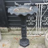 A black painted cast iron bird bath,