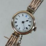 An early 20th century 9 carat rose gold case ladies wristwatch, with a painted enamel dial,