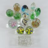 A collection of twelve various glass paperweights, together with a crystal tray,