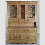 A pine dresser, with glazed doors,