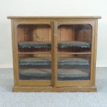 A 19th century grained pine glazed dwarf bookcase,