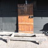 A stained pine door, 180 x 87cm, together with an antique wooden stand,