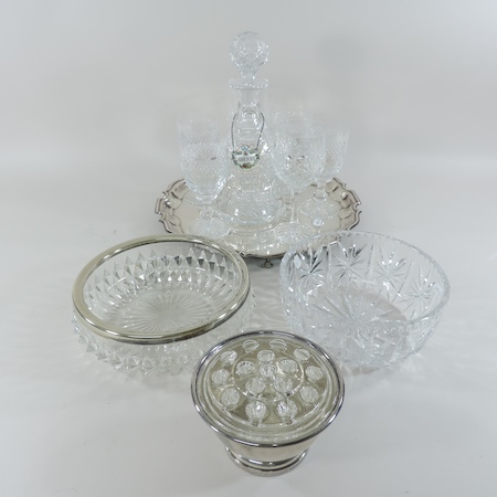 A collection of cut glass wine glasses, together with a decanter, cut glass bowls,